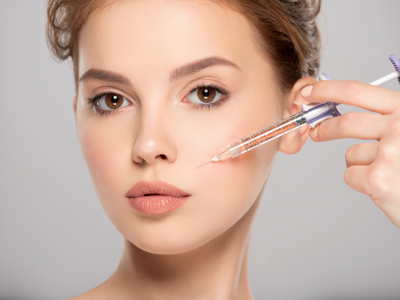 Woman Getting Cosmetic Injection of Botox in Cheek, Closeup. Wom