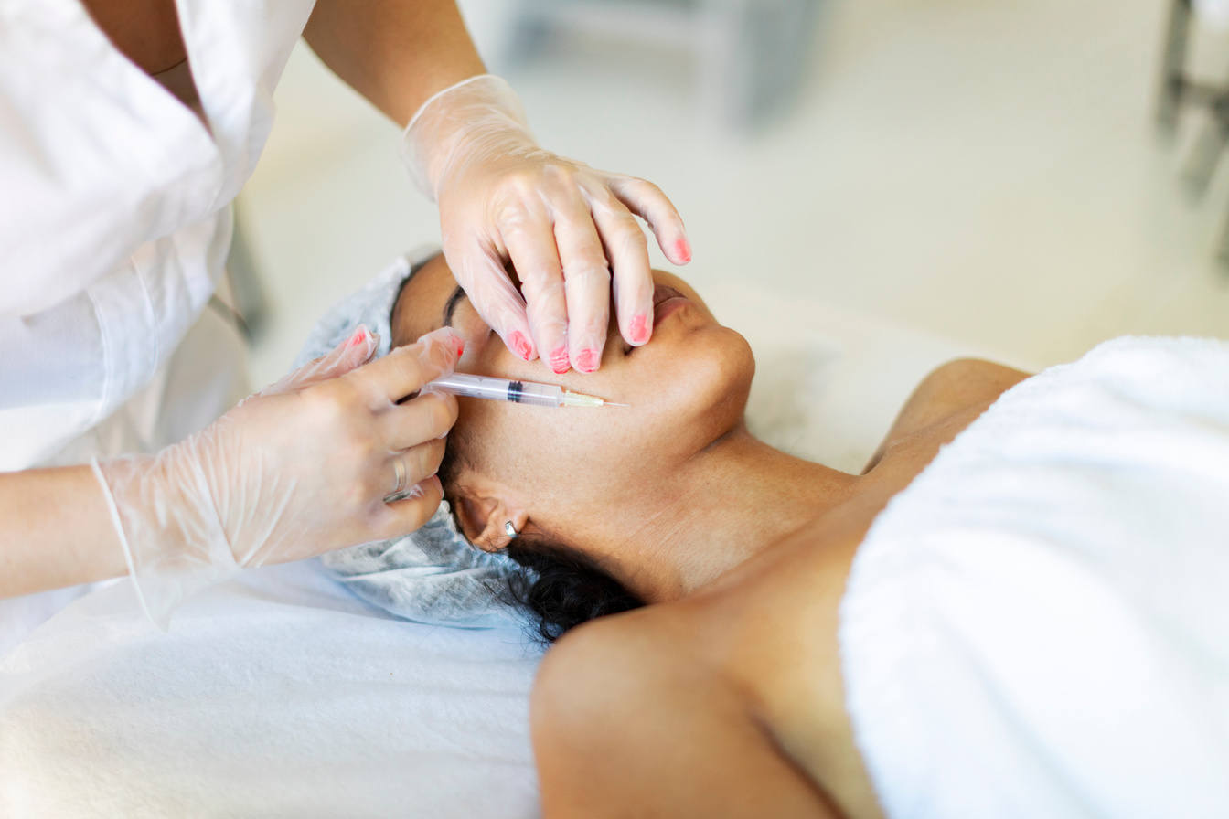 Cosmetologist making face meso therapy